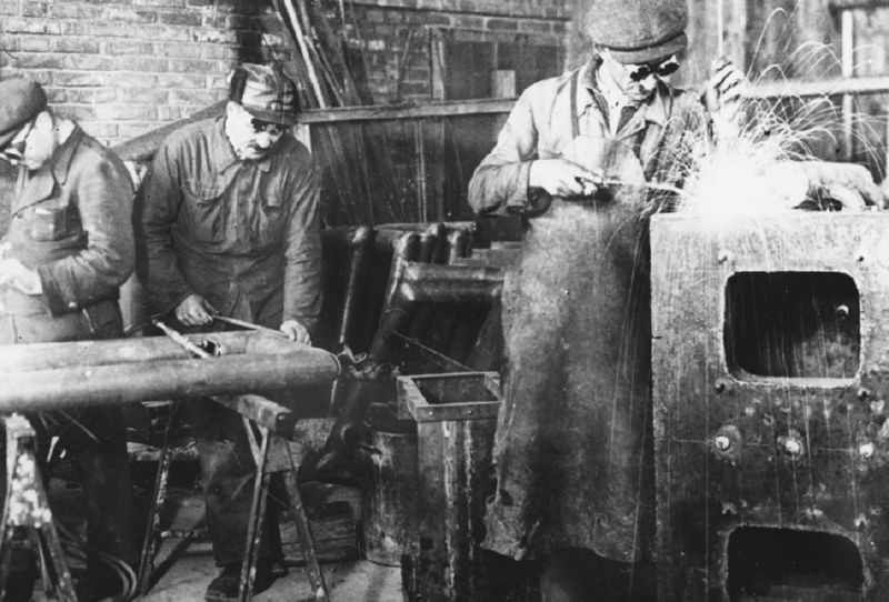 Prisoners weld metal at a Slovakian labor camp